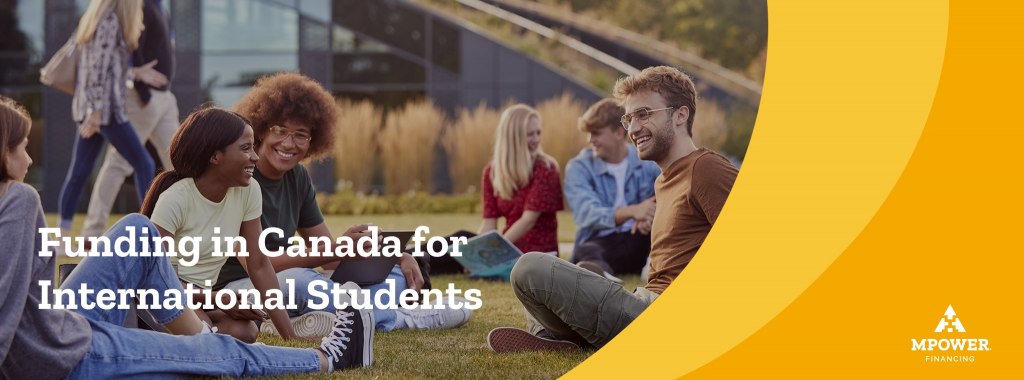 Diverse group of international students sitting outside on the grass on a college campus talking